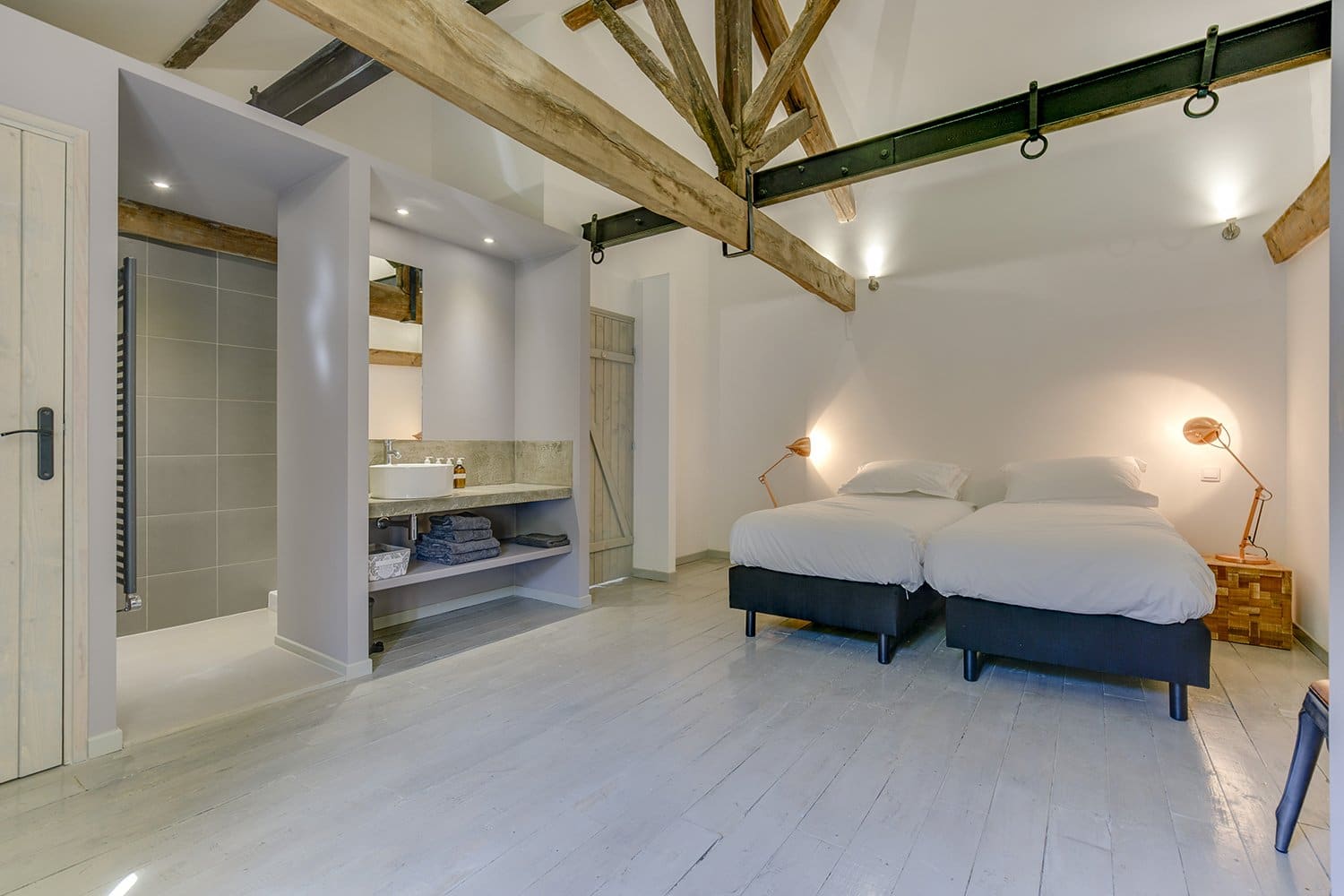 Gite bedroom and bathroom with exposed ceiling beams