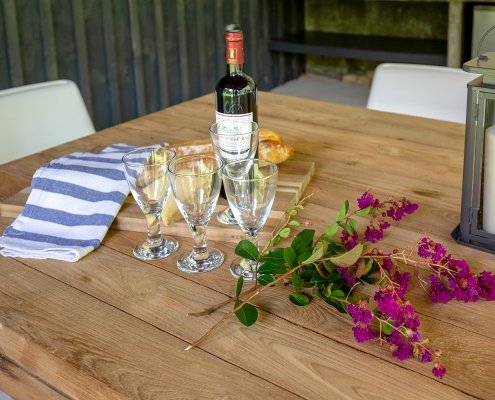 Flowers, glasses and French wine on a table