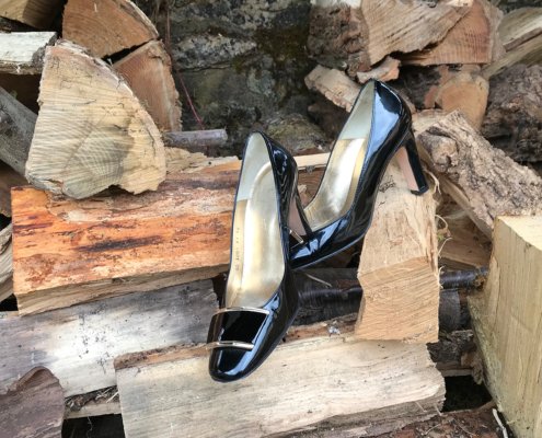 Heels on a pile of logs in the Dordogne