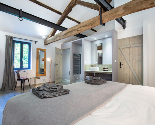 Interior of gite bedroom with exposed roof beams