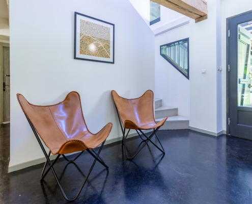 Beautiful leather chairs in hallway of gite