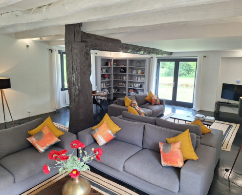 Beautiful gite lounge with matching sofas and original timber beams