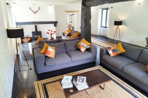 Beautiful rustic gite lounge with exposed support beam and fireplace
