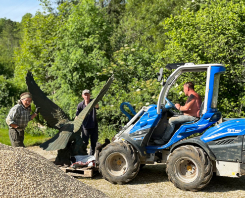 A digger is used to help move the statue