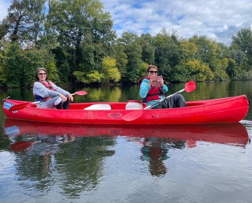 Two friends having fun in a canoe on the River Dordogne