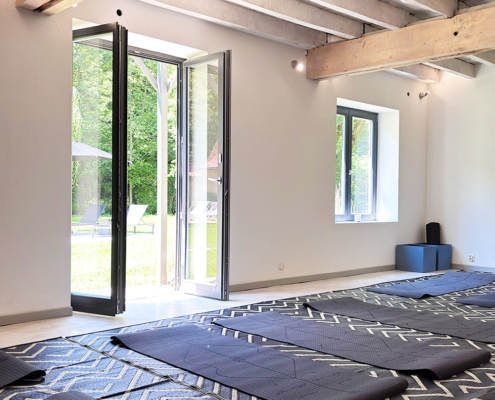 Dordogne yoga room with exposed beam ceilings and yoga mats on the floor