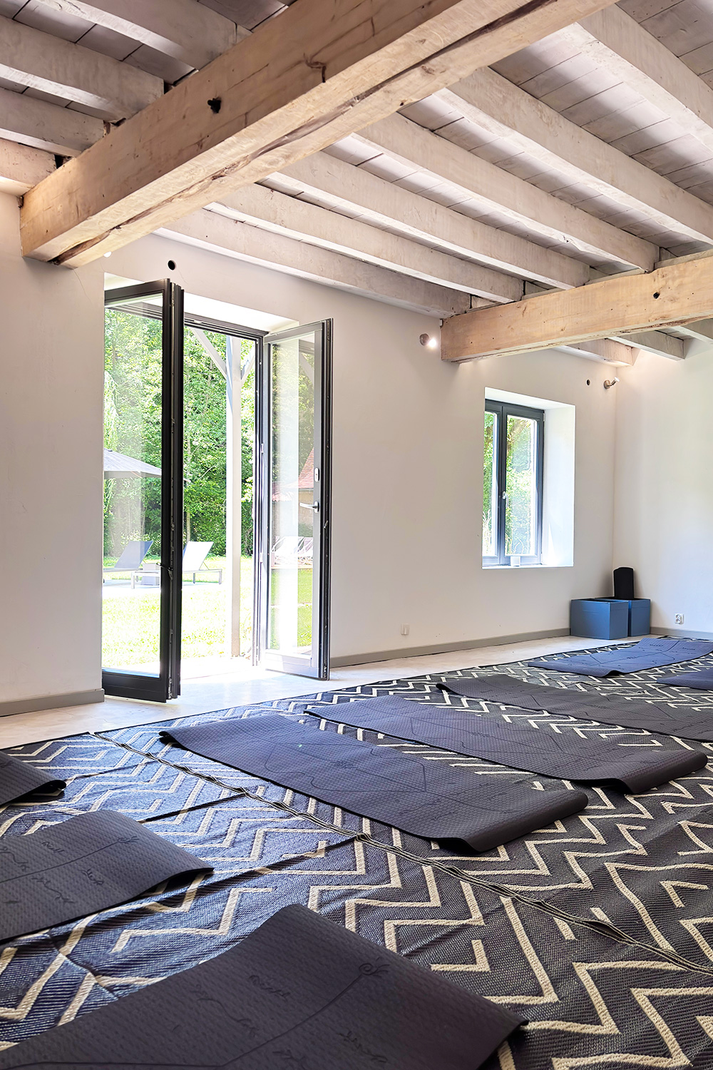 Dordogne yoga room with exposed beam ceilings and yoga mats on the floor