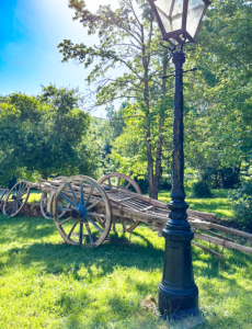 Restored wagon in the Dordogne sun Restored hay waggon by an antique lamppost in the Dordogne countryside