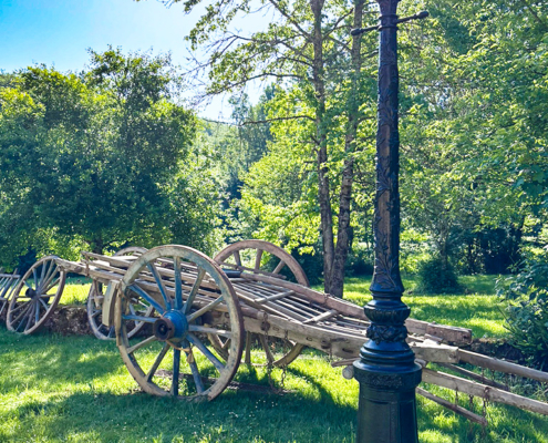 Restored wagon in the Dordogne sun Restored hay waggon by an antique lamppost in the Dordogne countryside