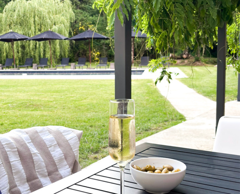 Wine and olives Table on the terrace with a glass of wine and a bowl of olives